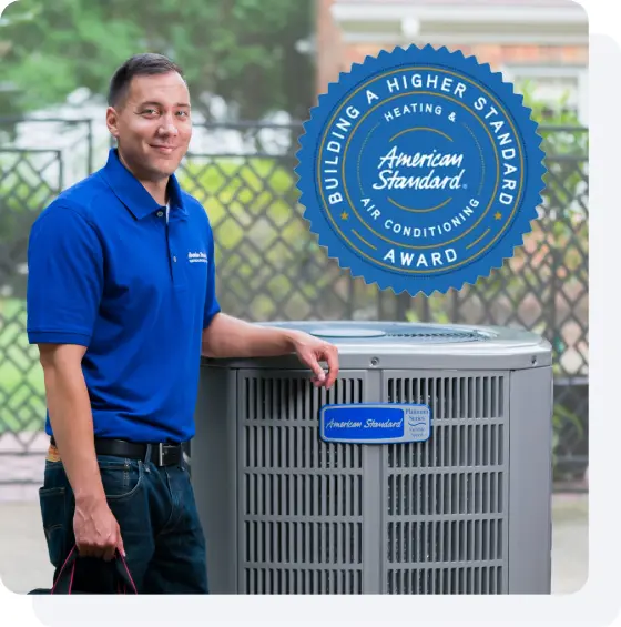 American Standard Building a Higher Standard award beside HVAC equipment