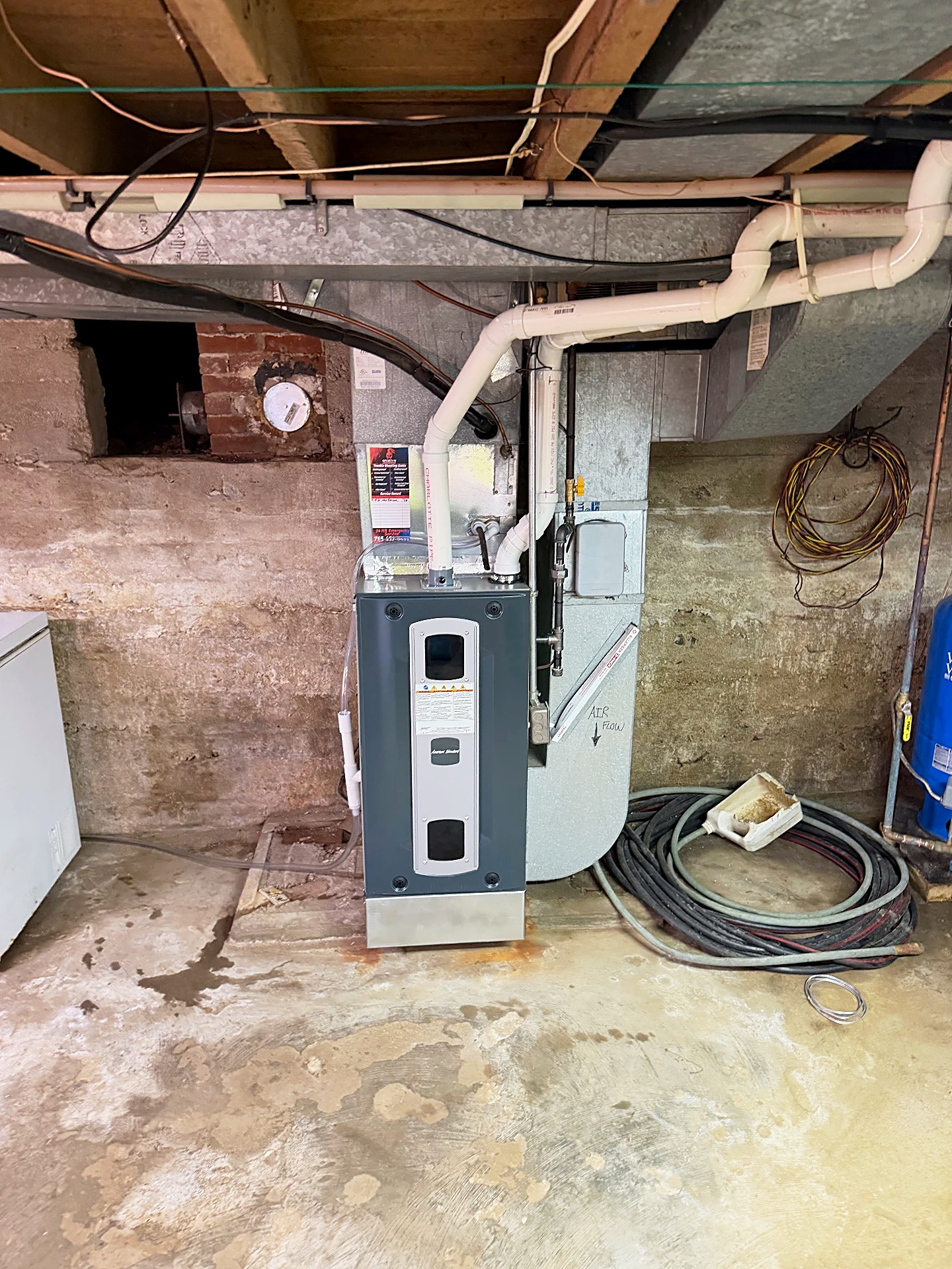 American Standard furnace and ductwork installed in a basement mechanical room